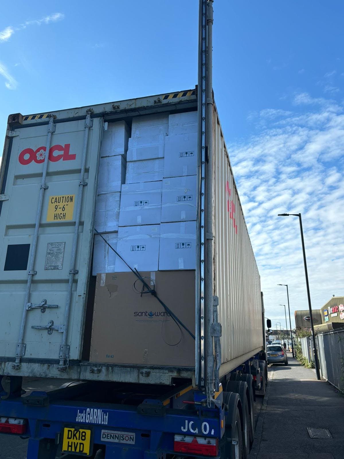 Open shipping container loaded with boxed plumbing and sanitaryware products
