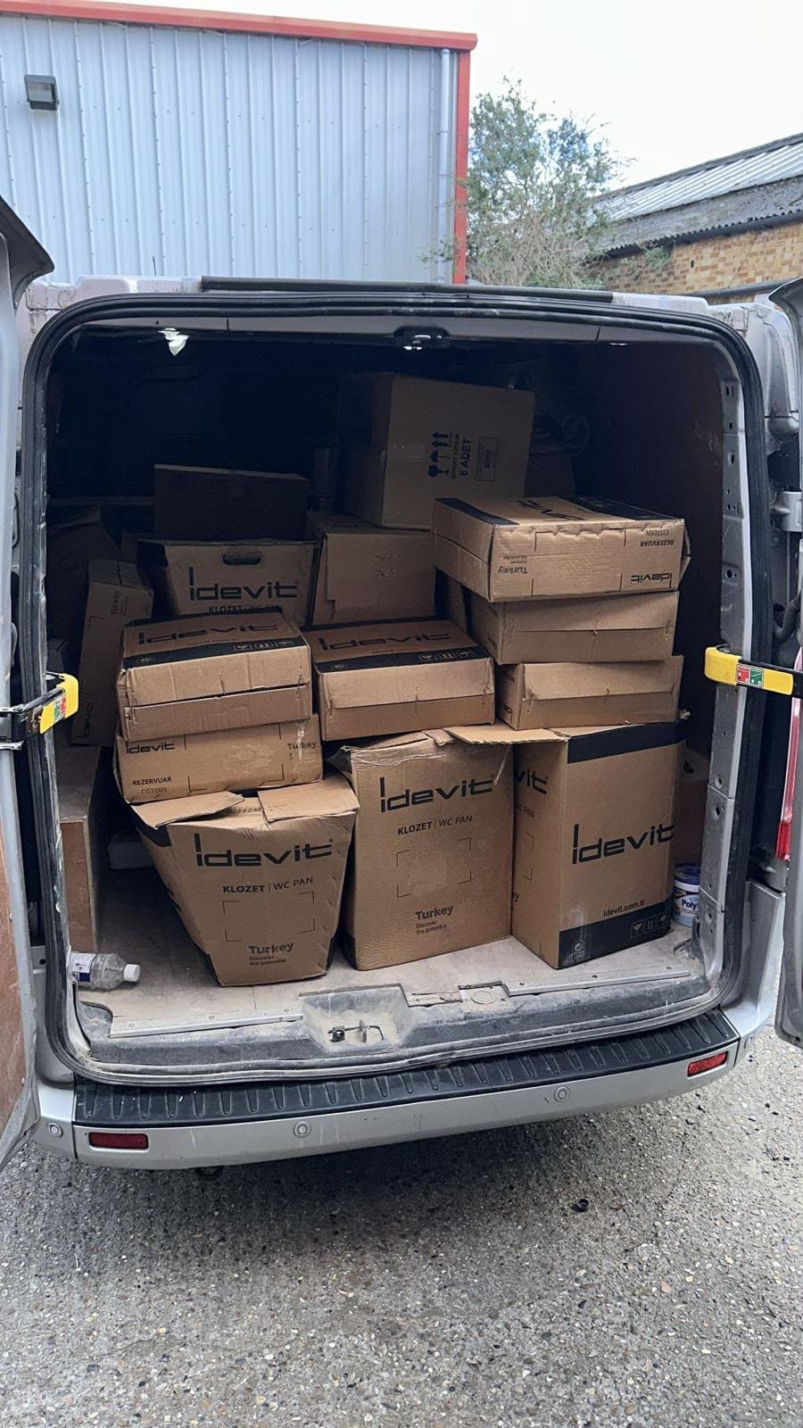 Van loaded with boxed WC pans and cisterns